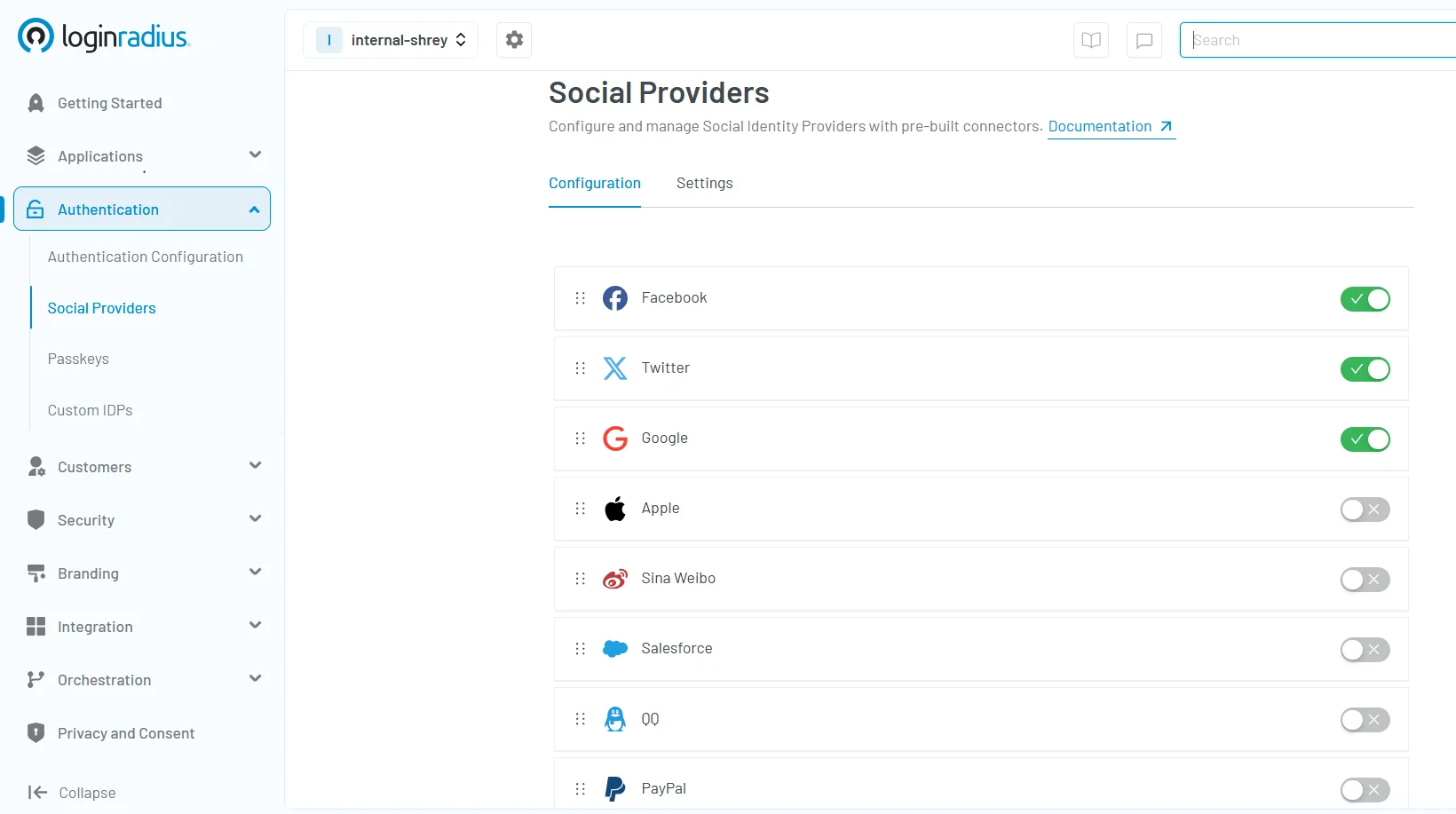 Social login configuration screen in the LoginRadius Dashboard showing enabled and disabled identity providers like Facebook, Google, and Twitter.